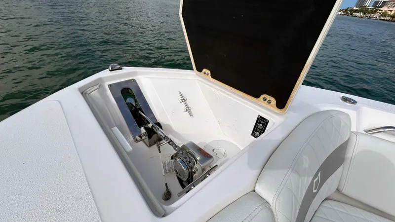 Slide: The Image of 2024 Sea Fox 268 Commander boat anchor compartment open on calm water. - 21