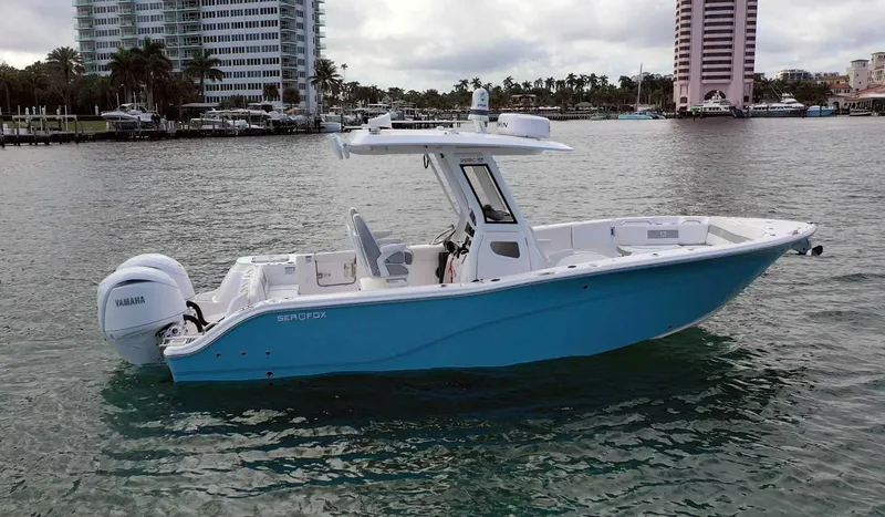 Slide: The Image of 2024 Sea Fox 268 Commander boat on water, cityscape background. - 3