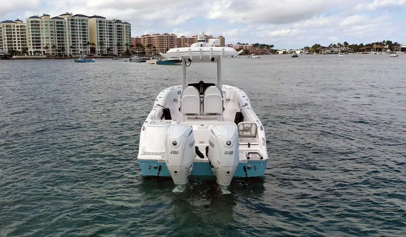 Slide: The Image of 2024 Sea Fox 268 Commander boat on water with twin engines, coastal buildings in background. - 6