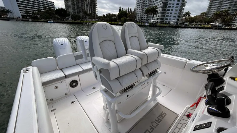 Slide: The Image of 2024 Sea Fox 268 Commander boat interior with dual seats and water view. - 7