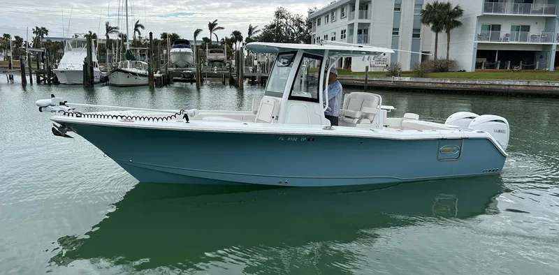 Slide: The Image of 2024 Sea Hunt Gamefish 27 boat with coffin box on calm water. - 0