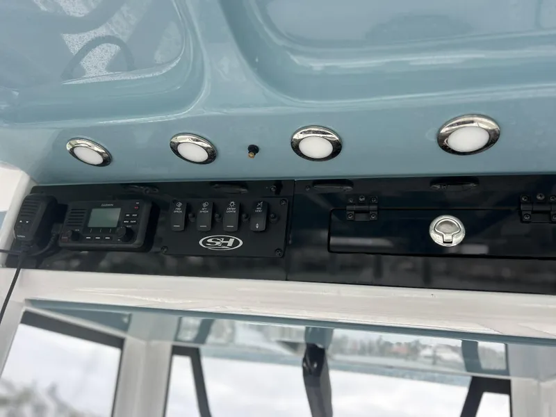 Slide: The Image of 2024 Sea Hunt Gamefish 27 control panel with switches and electronics. - 11