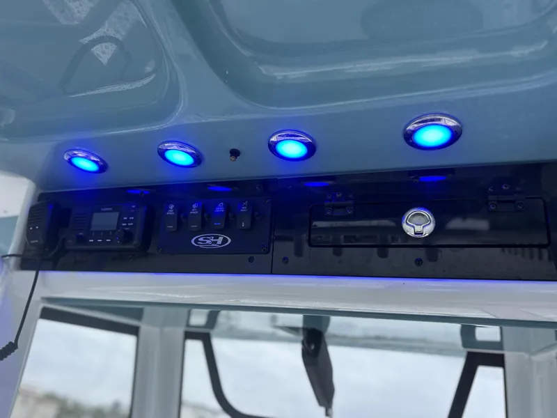 Slide: The Image of 2024 Sea Hunt Gamefish 27 control panel with blue LED lights. - 12