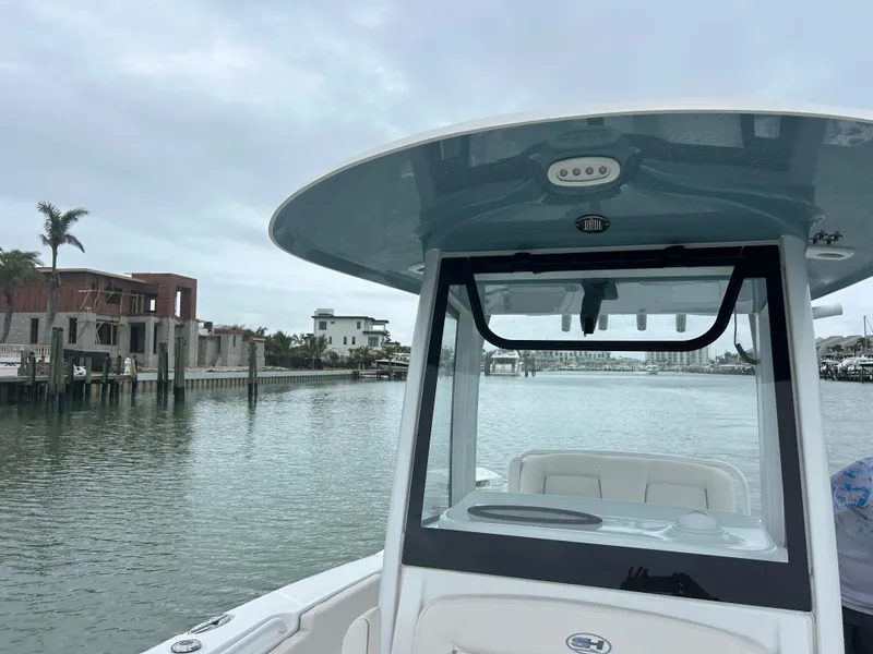 Slide: The Image of 2024 Sea Hunt Gamefish 27 with Coffin Box on calm waters, modern coastal backdrop. - 15