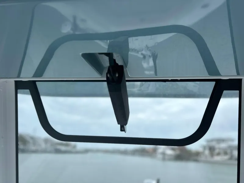 Slide: The Image of 2024 Sea Hunt Gamefish 27 windshield wiper detail, overlooking a serene waterway. - 16
