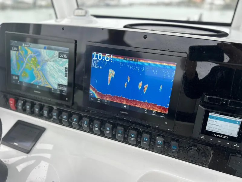 Slide: The Image of 2024 Sea Hunt Gamefish 27 dashboard with navigation and sonar displays. - 18