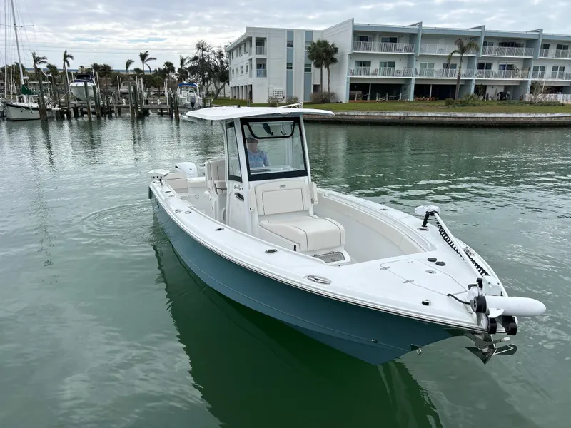 Slide: The Image of 2024 Sea Hunt Gamefish 27 boat with coffin box on calm water near marina. - 2