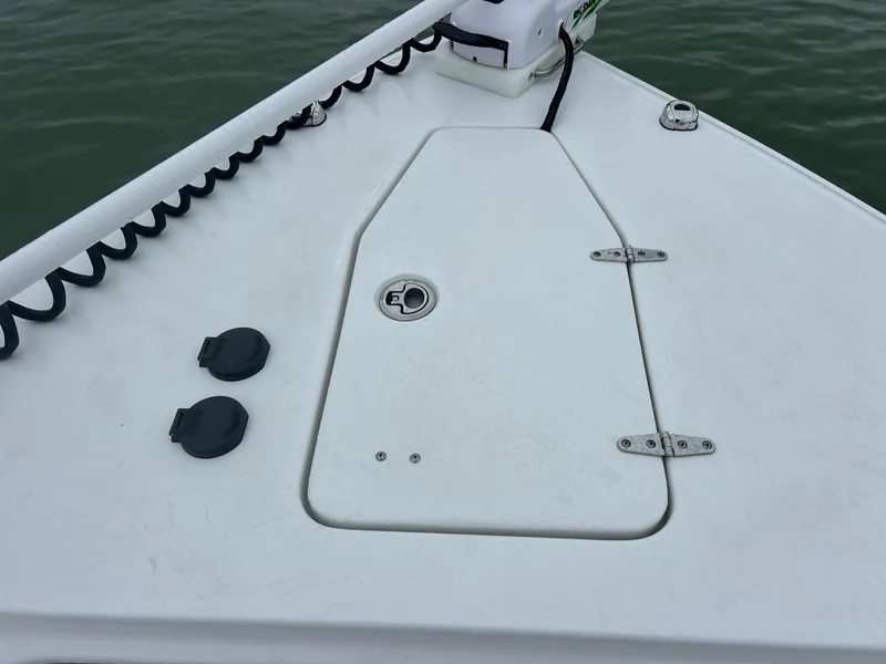 Slide: The Image of 2024 Sea Hunt Gamefish 27 boat deck with coffin box, white surface, and hardware. - 24