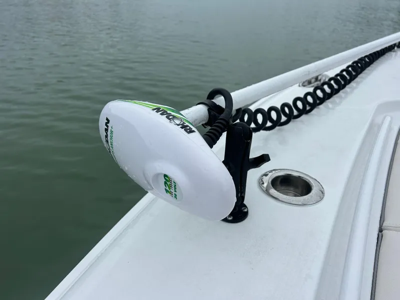 Slide: The Image of 2024 Sea Hunt Gamefish 27 boat with trolling motor on deck, near water. - 25