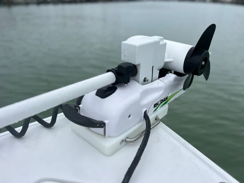 Slide: The Image of Trolling motor on 2024 Sea Hunt Gamefish 27 with Coffin Box, near water. - 26