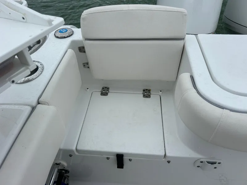 Slide: The Image of 2024 Sea Hunt Gamefish 27 boat seating area with storage compartment. - 30