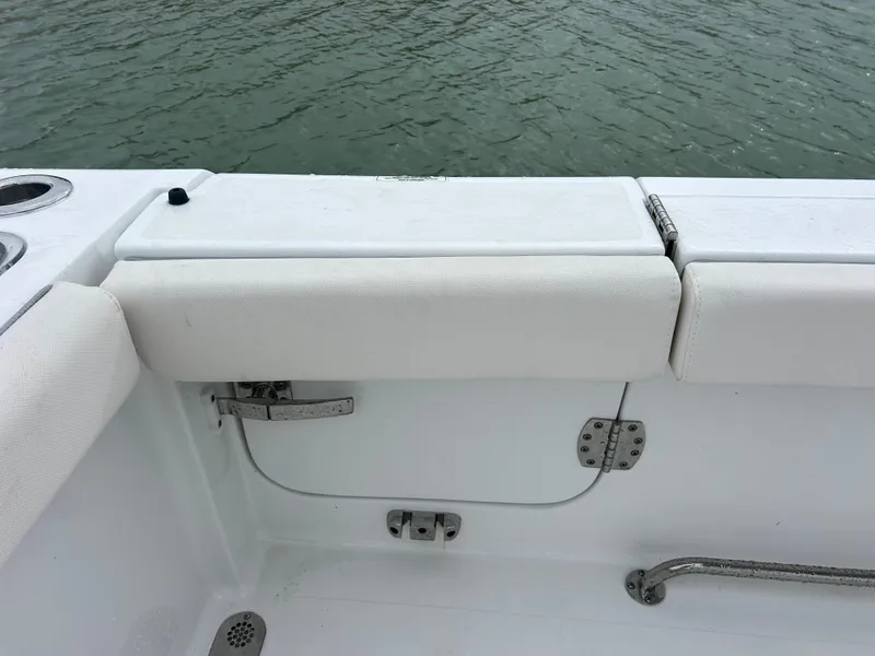 Slide: The Image of 2024 Sea Hunt Gamefish 27 boat interior with white seating and hardware details. - 31
