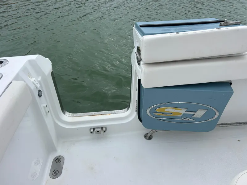 Slide: The Image of 2024 Sea Hunt Gamefish 27 boat deck with coffin box, open water view. - 32