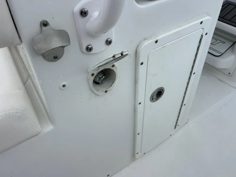 Slide: The Image of 2024 Sea Hunt Gamefish 27 boat detail, featuring a white panel and access hatch. - 37