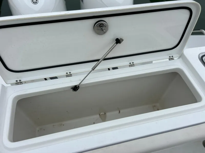 Slide: The Image of 2024 Sea Hunt Gamefish 27 coffin box open, showcasing spacious storage. - 42