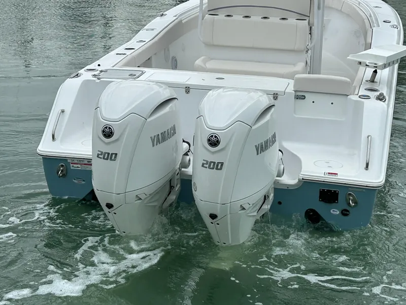 Slide: The Image of 2024 Sea Hunt Gamefish 27 with twin Yamaha 200 engines in water. - 6