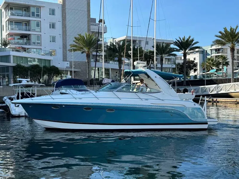 The Image of 2005 Formula 31 Performance Cruiser docked in a marina with palm trees and buildings. - 0