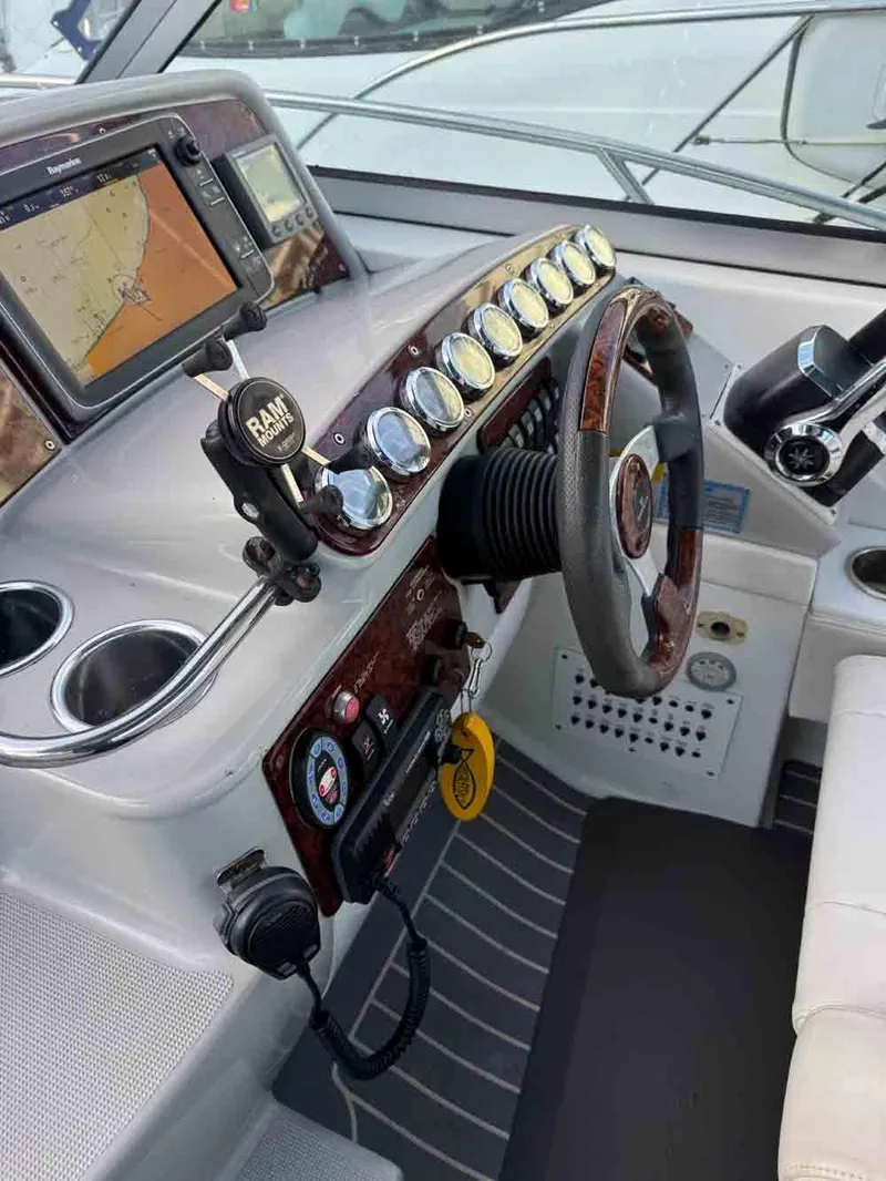 Slide: The Image of 2005 Formula 31 Performance Cruiser helm with GPS, gauges, and steering wheel. - 11