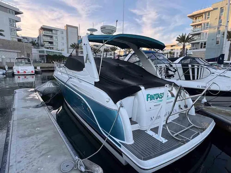Slide: The Image of 2005 Formula 31 Performance Cruiser docked at marina, featuring sleek design and blue accents. - 14