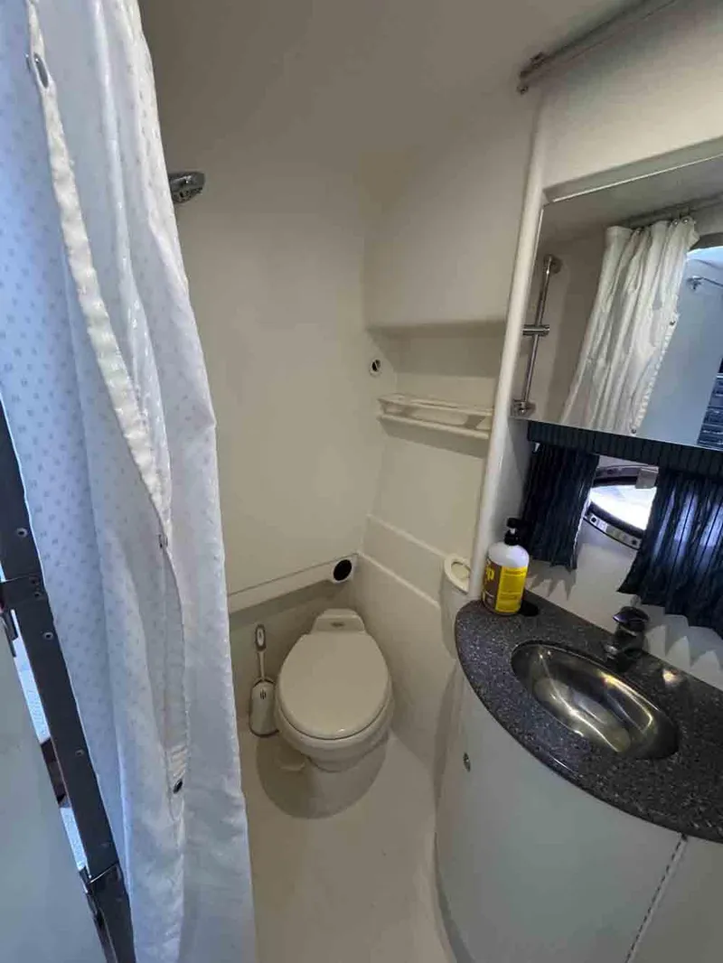 Slide: The Image of 2005 Formula 31 Performance Cruiser bathroom with shower, toilet, and sink. - 19