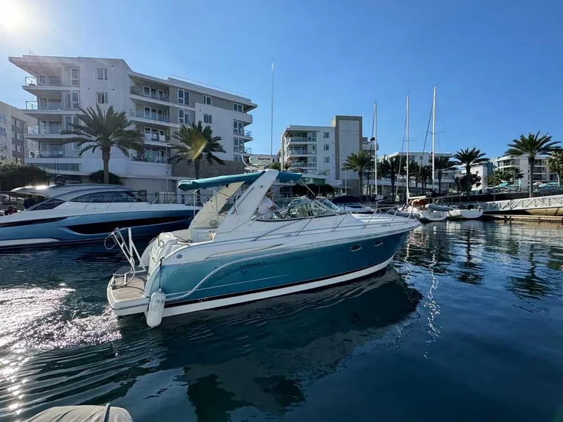 Slide: The Image of 2005 Formula 31 Performance Cruiser docked in a marina with modern buildings. - 2