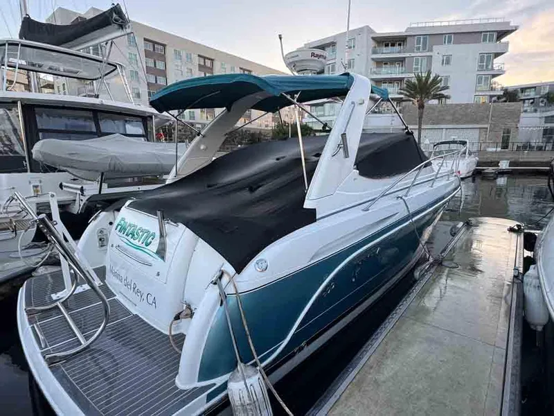 Slide: The Image of 2005 Formula 31 Performance Cruiser docked at marina, covered with black tarp. - 20