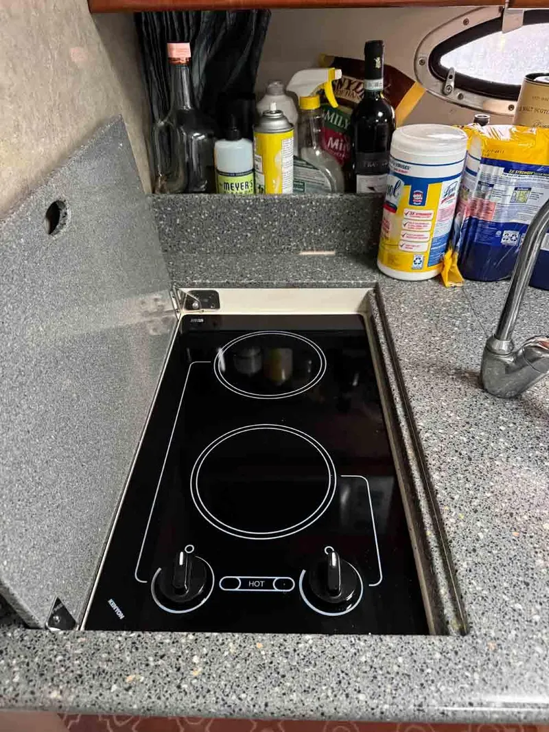 Slide: The Image of 2005 Formula 31 Performance Cruiser kitchen with electric stove and granite countertop. - 23