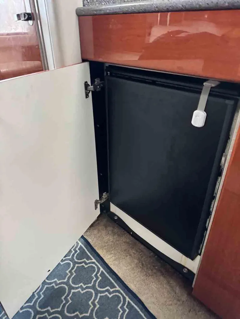 Slide: The Image of 2005 Formula 31 Performance Cruiser interior cabinet with black door and carpeted floor. - 24