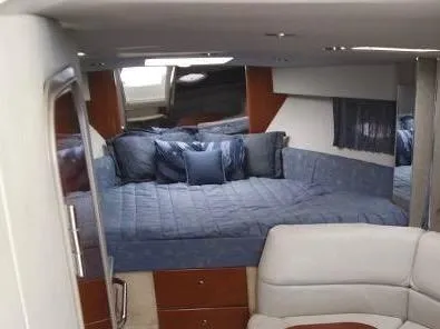 Slide: The Image of 2005 Formula 31 Performance Cruiser interior with blue bedding and seating area. - 32