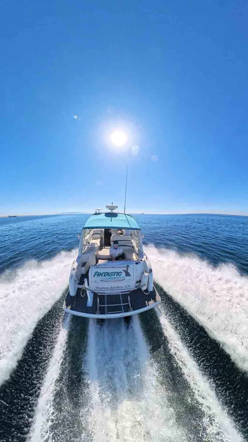 Slide: The Image of 2005 Formula 31 Performance Cruiser speeding on open water under clear blue sky. - 4