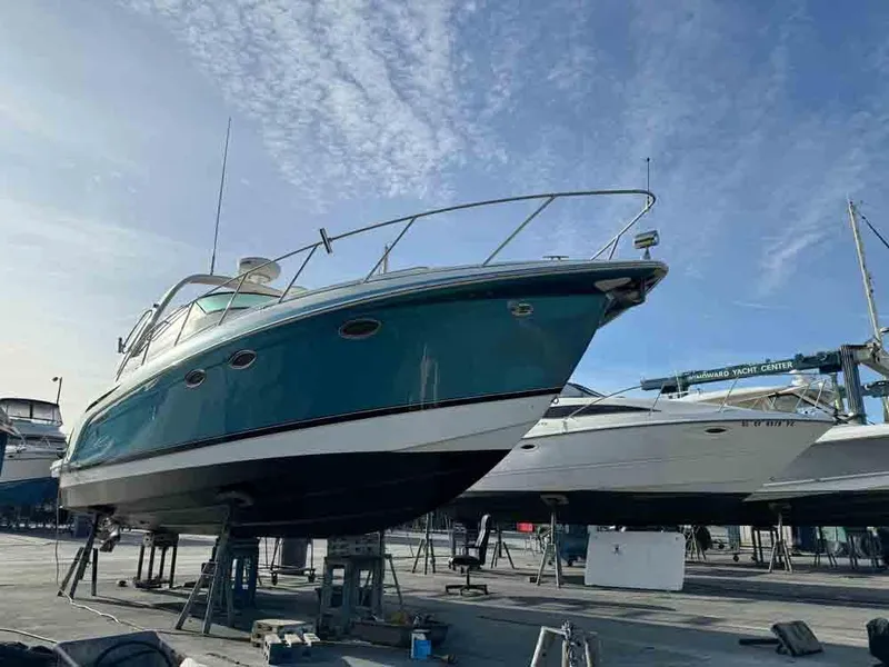 Slide: The Image of 2005 Formula 31 Performance Cruiser on stands, blue hull, clear sky background. - 6