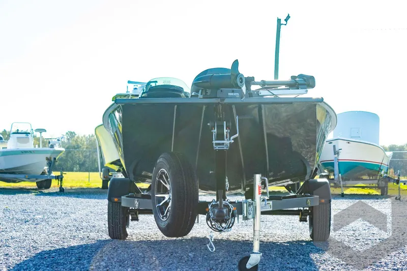 Slide: The Image of 2025 G3 Sportsman 1610 boat on trailer, parked outdoors on gravel. - 14