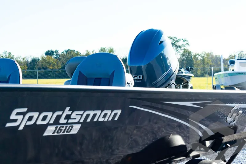 Slide: The Image of 2025 G3 Sportsman 1610 boat with powerful outboard motor in a sunny outdoor setting. - 20