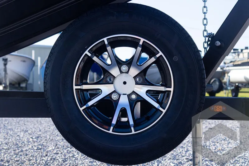Slide: The Image of 2025 G3 Sportsman 1610 trailer wheel with sleek black and silver alloy rim. - 33