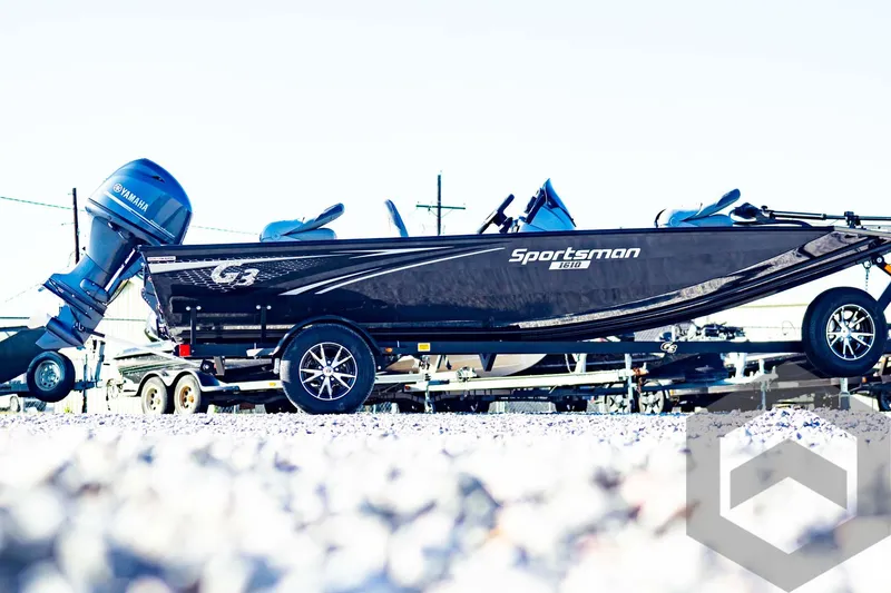 Slide: The Image of 2025 G3 Sportsman 1610 boat on trailer, side view, outdoors. - 5