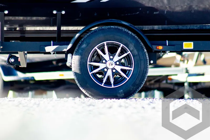 Slide: The Image of 2025 G3 Sportsman 1610 trailer wheel on gravel surface. - 7