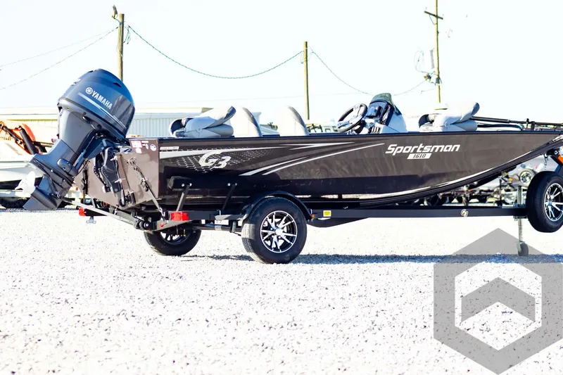 Slide: The Image of 2025 G3 Sportsman 1610 boat with Yamaha motor on a trailer in a gravel lot. - 8