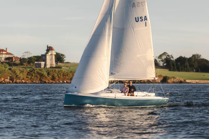 Slide: The Image of 2026 J Boats J/7 sailing near scenic coastline with historic buildings. - 0