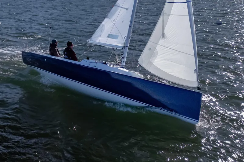 Slide: The Image of 2026 J Boats J/7 sailing on open water with two people onboard. - 1