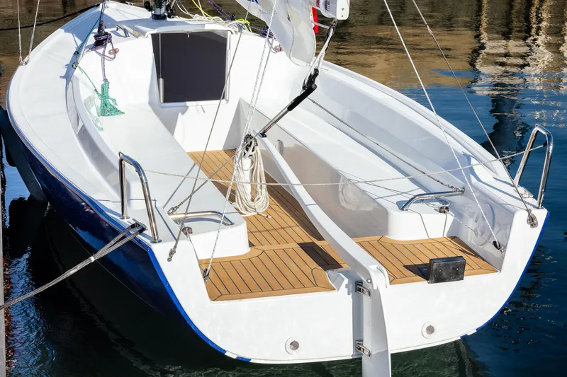 Slide: The Image of 2026 J Boats J/7 sailboat with sleek design and wooden deck, docked in calm waters. - 11