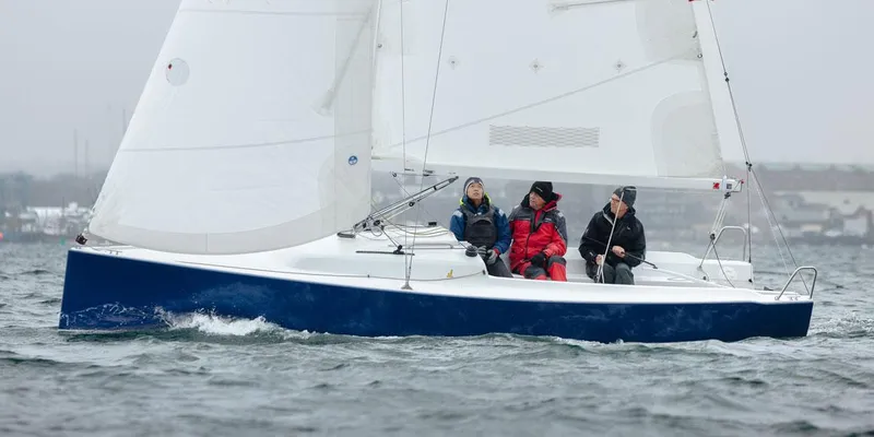 Slide: The Image of 2026 J Boats J/7 sailing with crew on a cloudy day. - 8