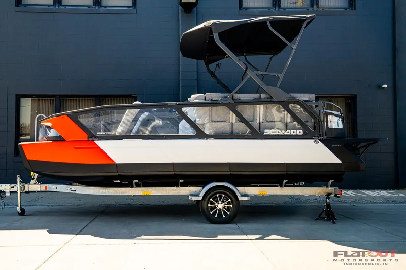 Slide: The Image of 2024 Sea-Doo Switch SPORT 21 230HP boat on trailer, black and orange design. - 19