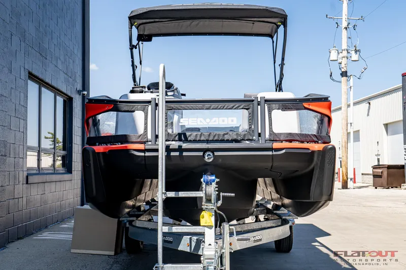 Slide: The Image of 2024 Sea-Doo Switch SPORT 21 230HP on trailer, rear view in industrial setting. - 2