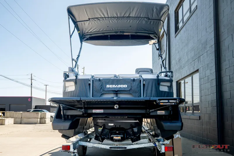 Slide: The Image of 2024 Sea-Doo Switch SPORT 21 230HP pontoon boat on trailer, rear view. - 20
