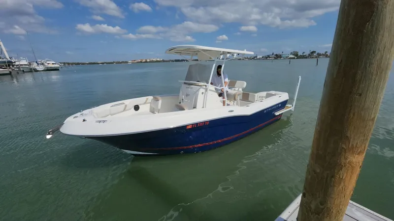 Slide: The Image of 2014 Striper 220 Center Console boat on calm water under a partly cloudy sky. - 1