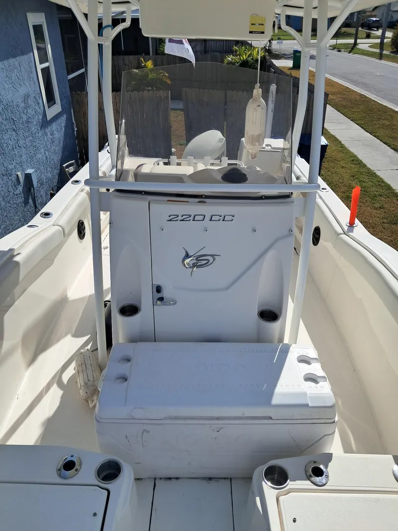 Slide: The Image of 2014 Striper 220 Center Console boat interior with seating and storage. - 10
