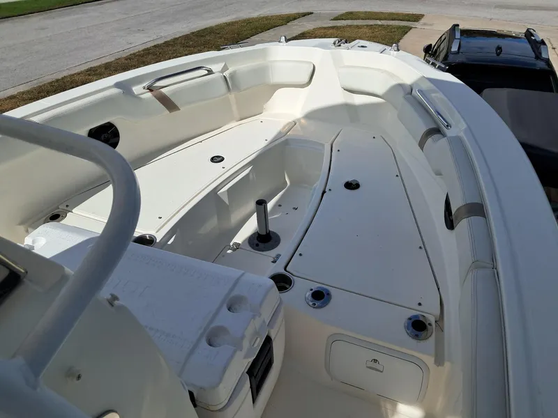 Slide: The Image of 2014 Striper 220 Center Console boat interior with seating and storage compartments. - 12