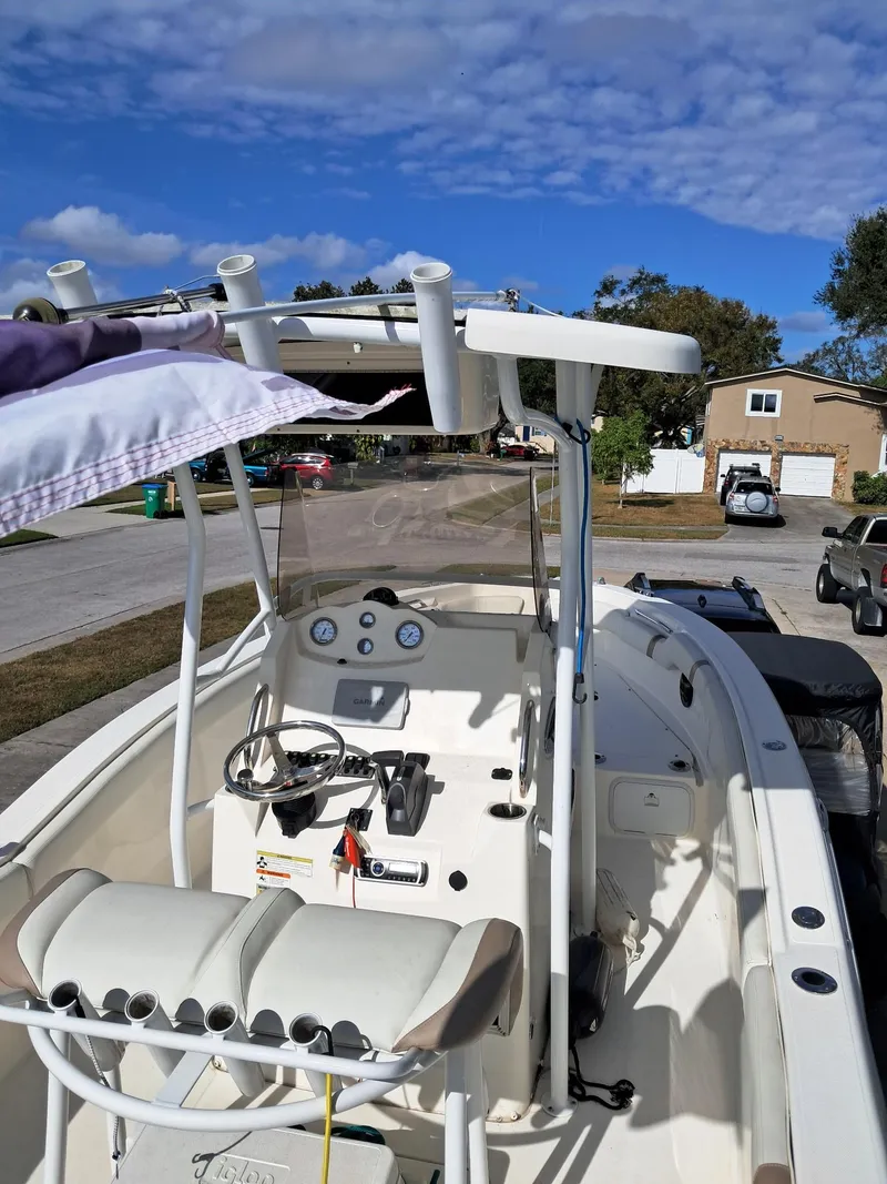 Slide: The Image of 2014 Striper 220 Center Console boat parked on a sunny residential street. - 13