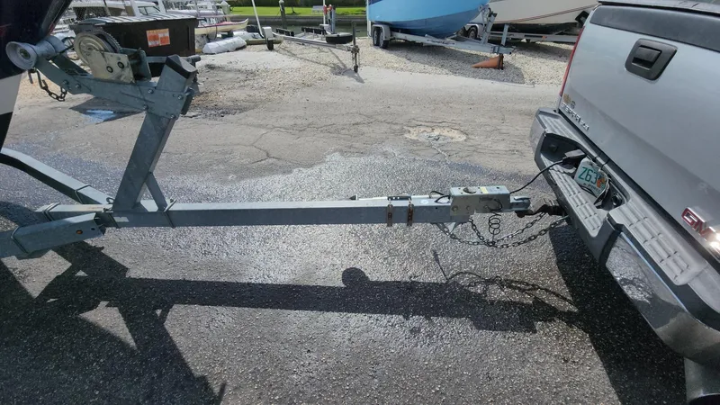Slide: The Image of Trailer hitch connected to a truck, towing a 2014 Striper 220 Center Console boat. - 19