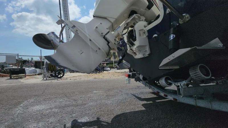 Slide: The Image of 2014 Striper 220 Center Console boat engine on trailer, outdoor setting. - 23